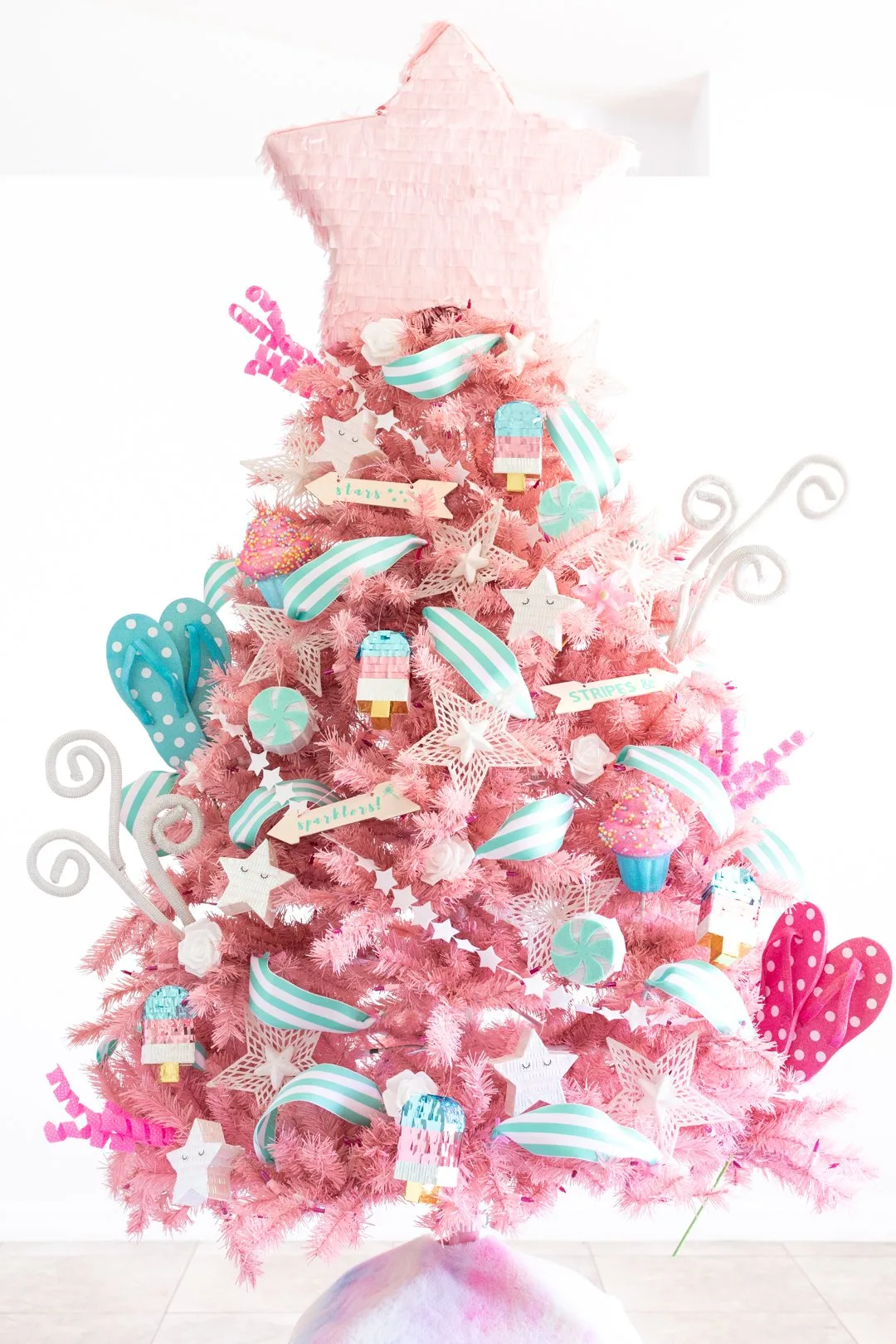pink patriotic summer christmas tree with a pink star pinata tree topper