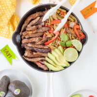 Steak fajitas prepared and ready to be served out of a skillet