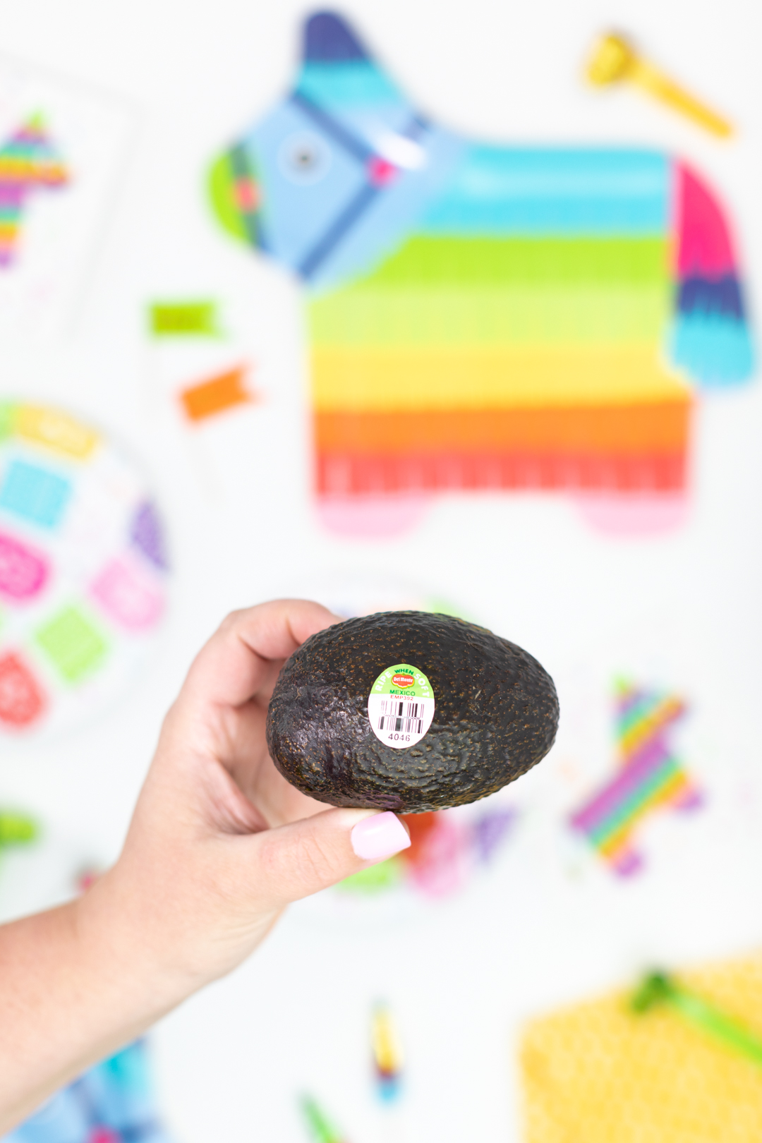 woman holding del monte avocado