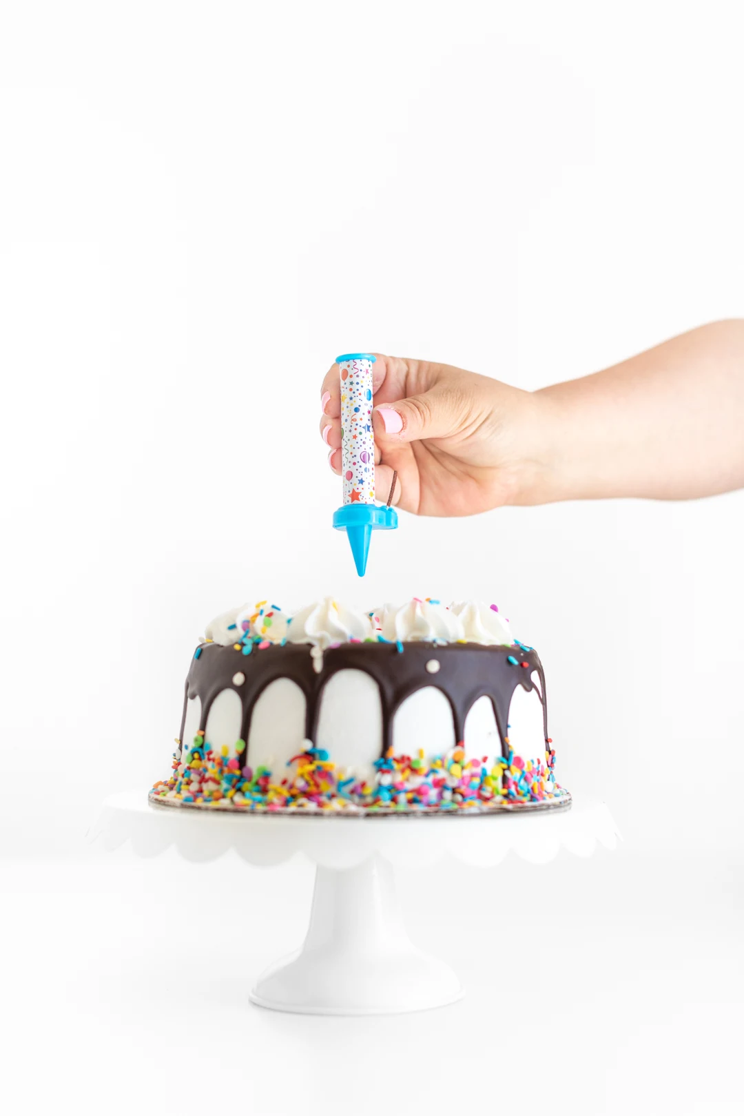 adding a surprise candle on top of a birthday cake