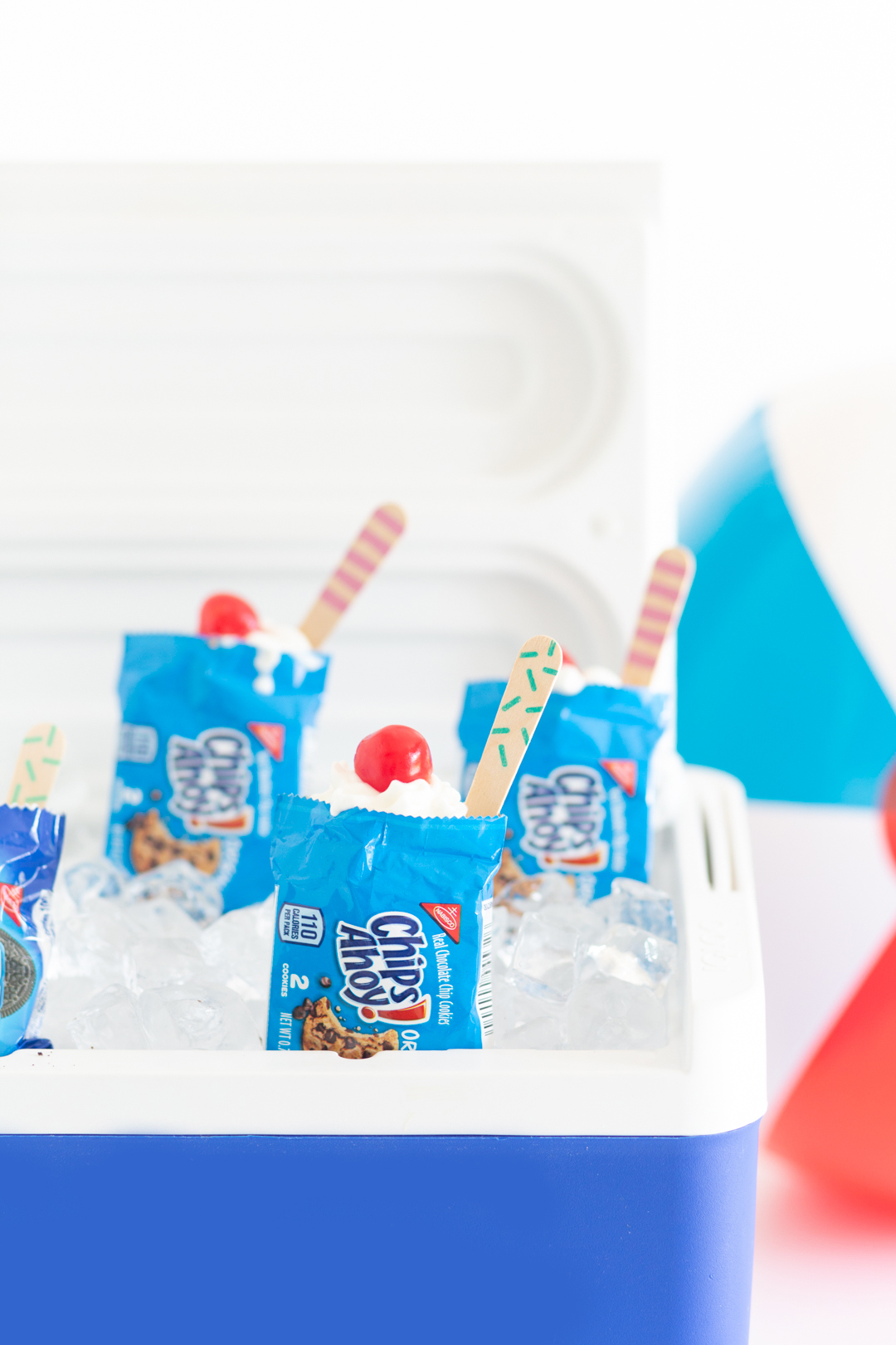 handheld desserts being served out of a cooler with ice