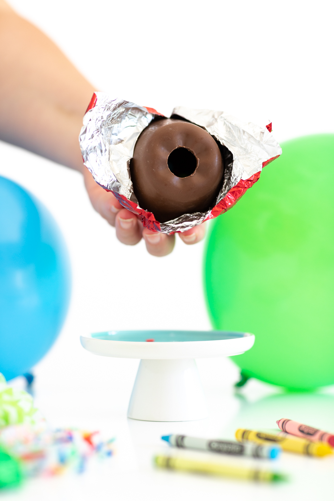 woman holding hollow chocolate apple with hole in the center