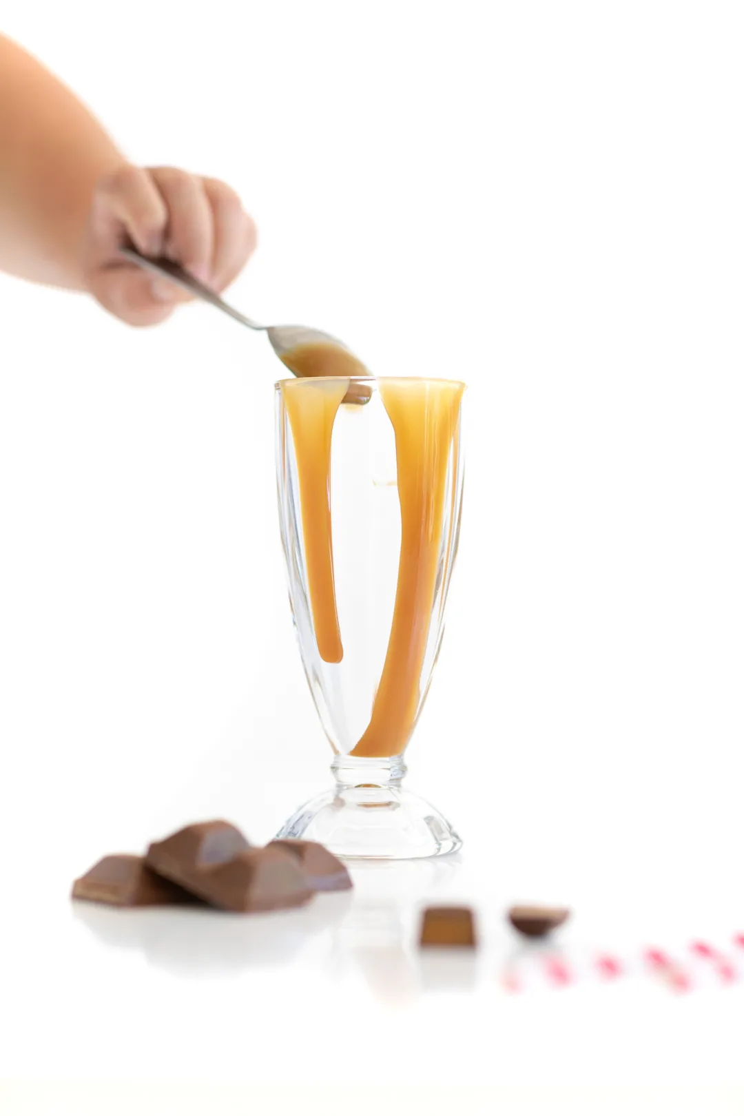 adding caramel to a glass to decorate