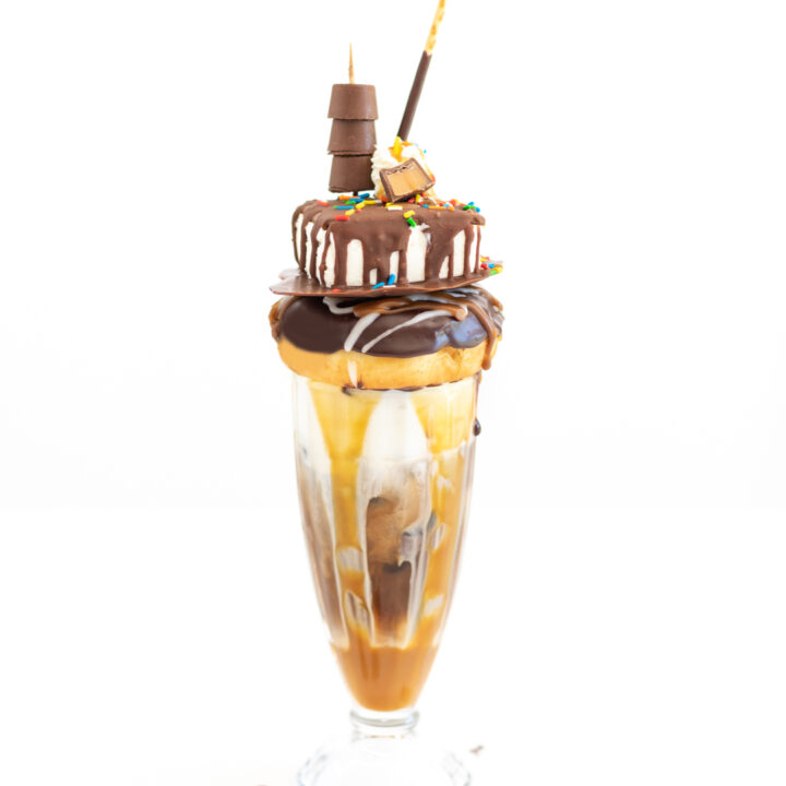 photo of very fancy iced coffee with lots of chocolate and caramel syrups and candies.