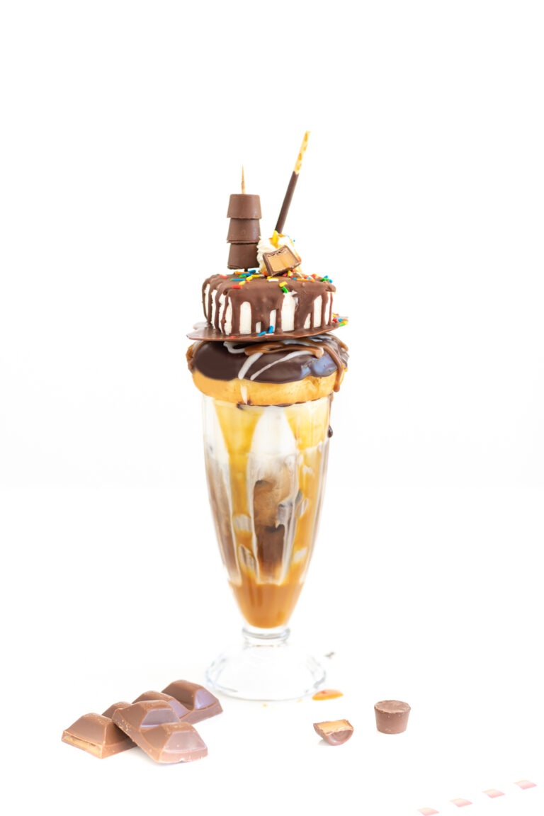 photo of very fancy iced coffee with lots of chocolate and caramel syrups and candies.