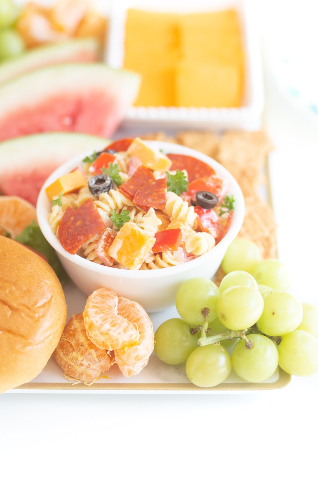 bbqterie tray with bowl of pasta salad, fresh fruits