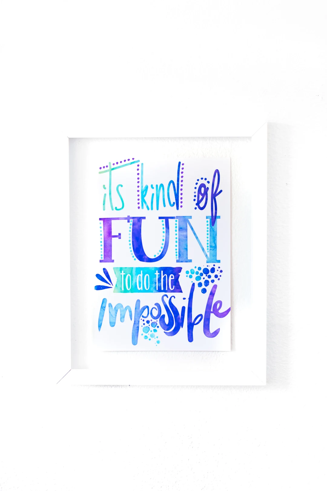 small poster hung on the bathroom wall that reads "it's kind of fun to do the impossible". A walt disney quote printed through an artist on redbubble.