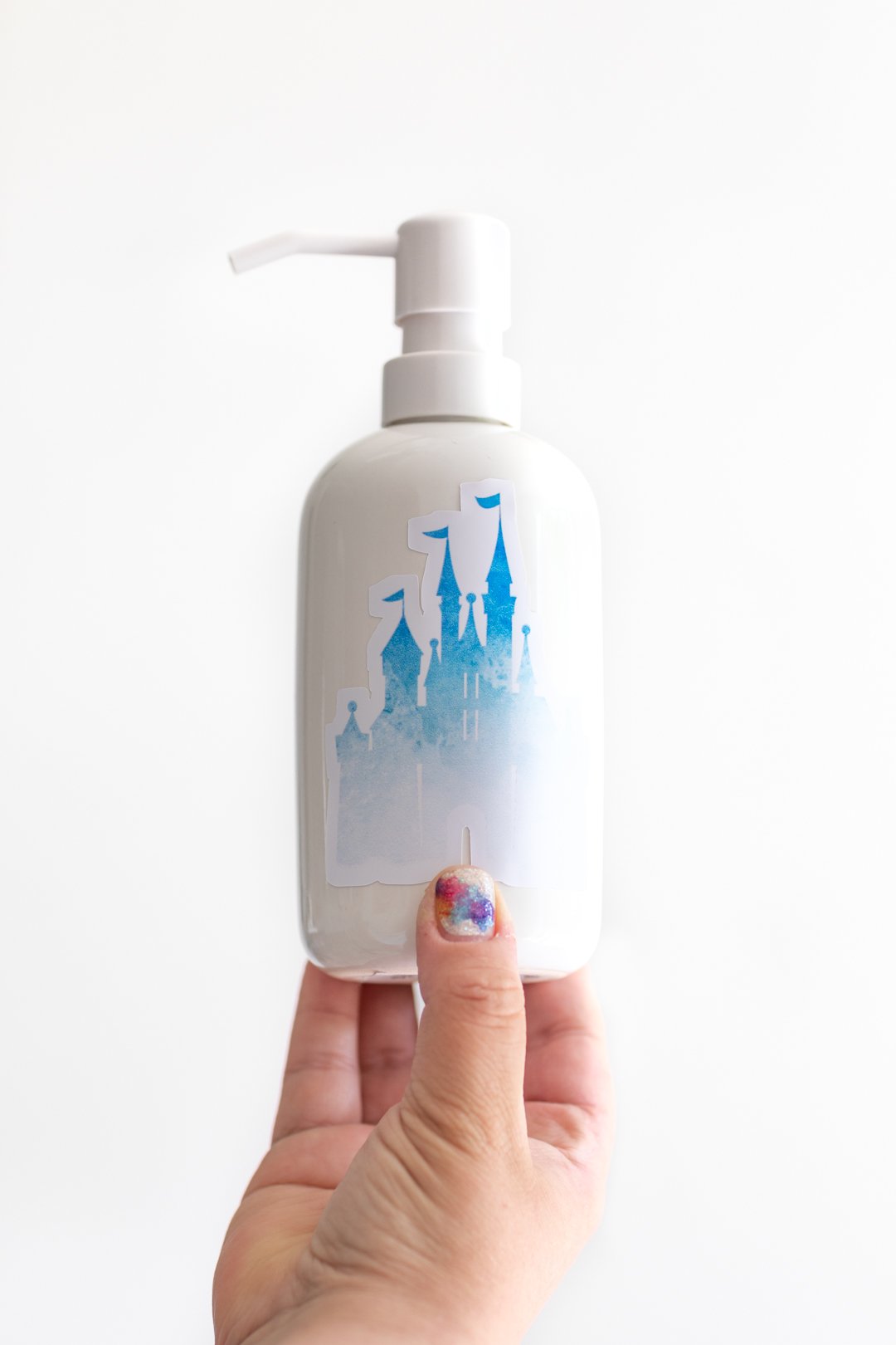 white soap dispenser with a disney castle sticker on it to decorate