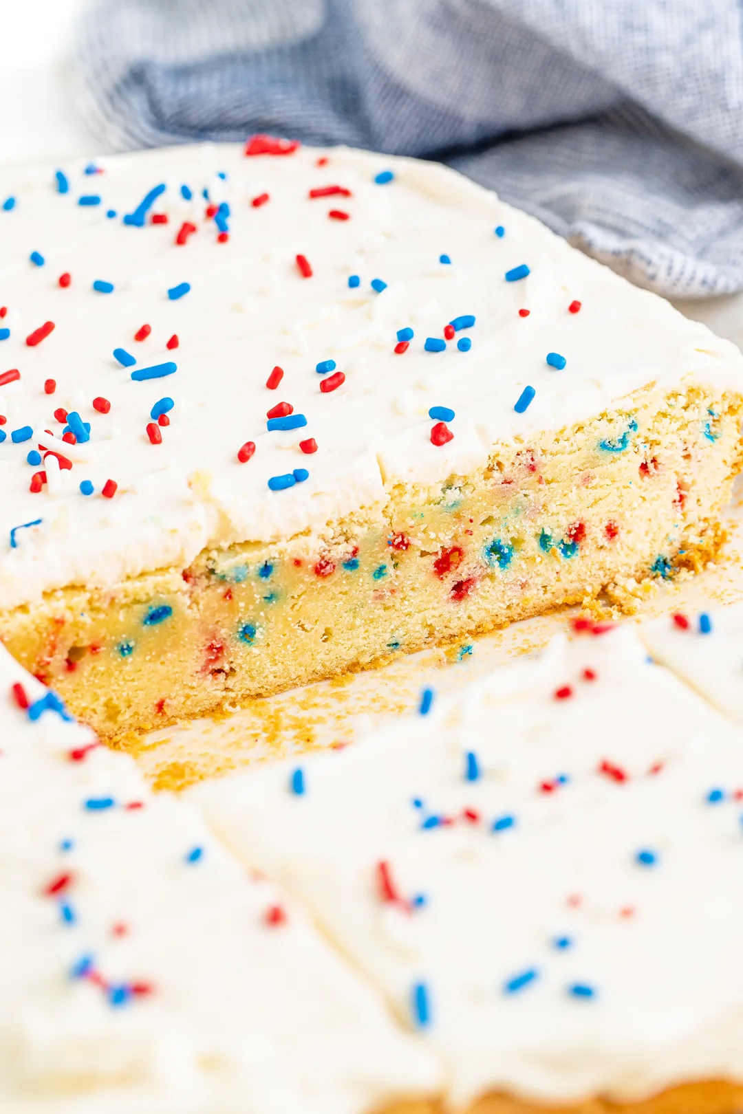 inside view of a huge sugar cookie slap with patriotic colored sprinkles inside and on top of frosting.