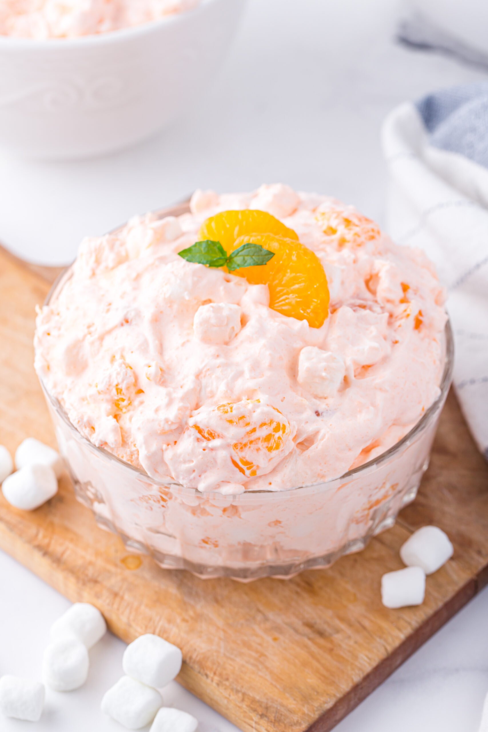 dish of mandarin orange fluff on a wooden cutting board