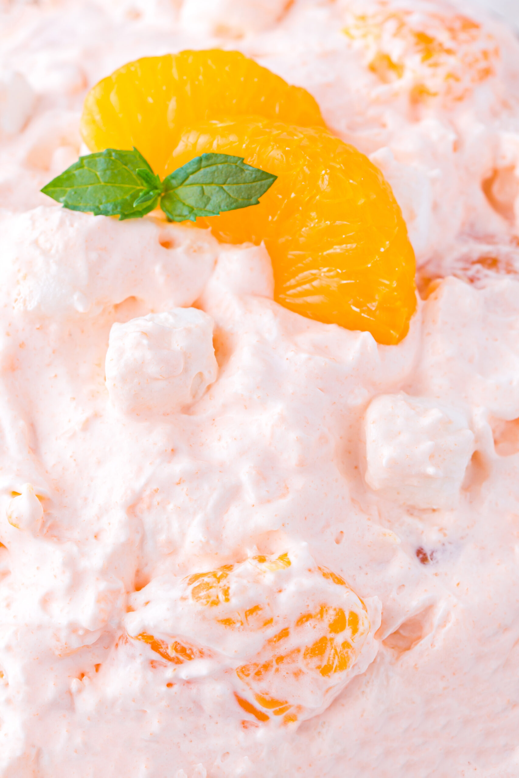 extremely up close view of a bowl of mandarin fluff salad