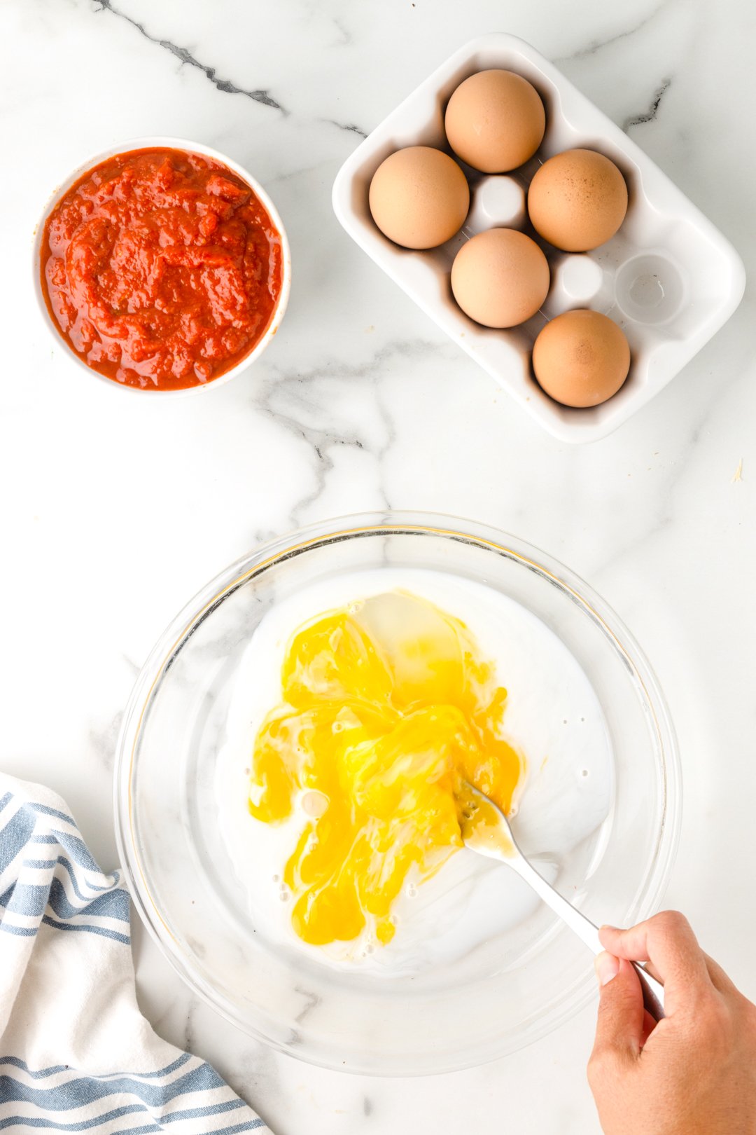 preparing egg mixture for breading ravioli