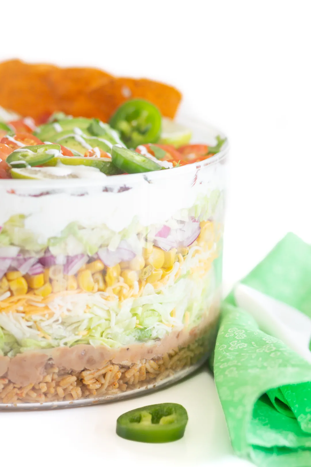 up close view of layers of salad in a glass serving bowl.