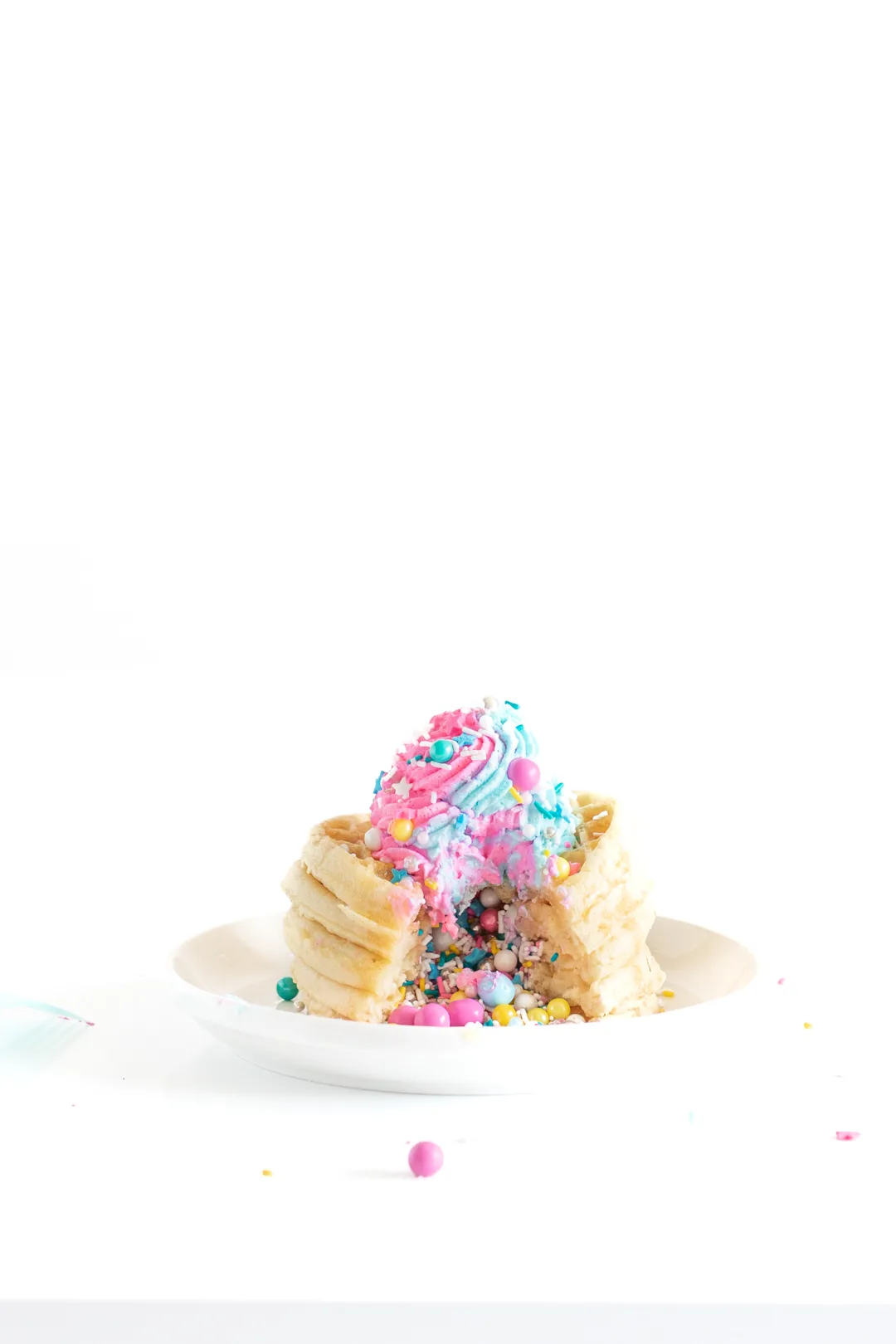 stack of waffles with sprinkles coming out of the center like a piñata 