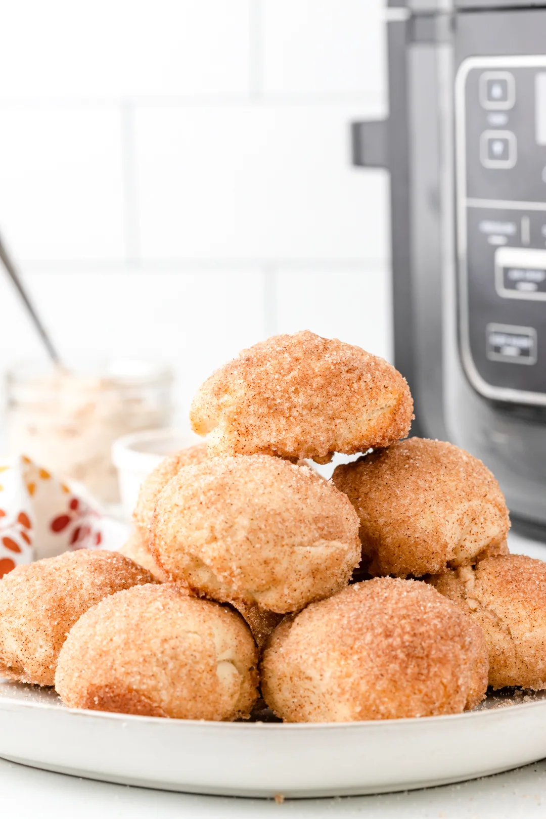 stack of donut bites with air fryer in the background