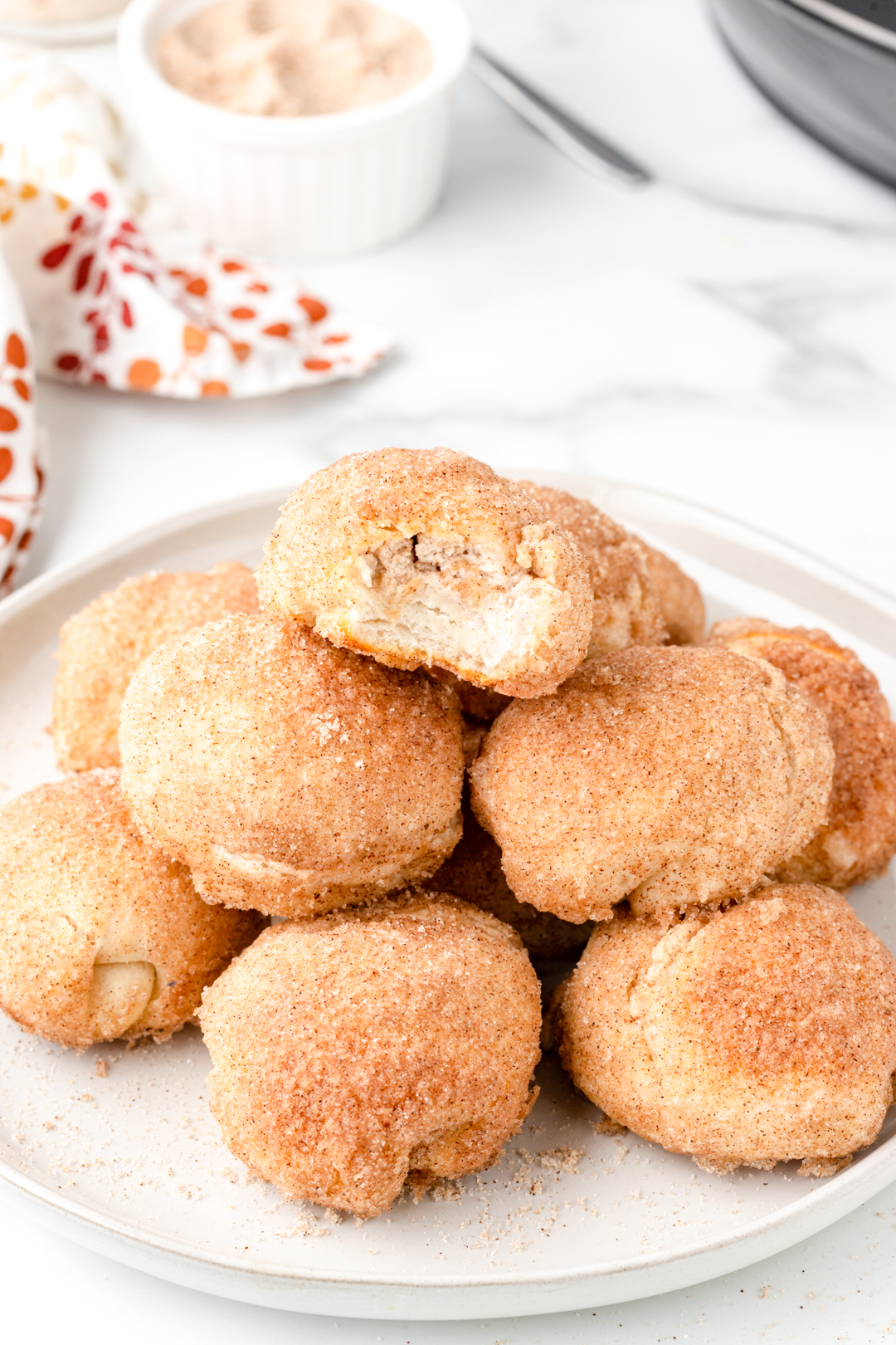 plate of pumpkin spice donut holes stuffed with cream cheese