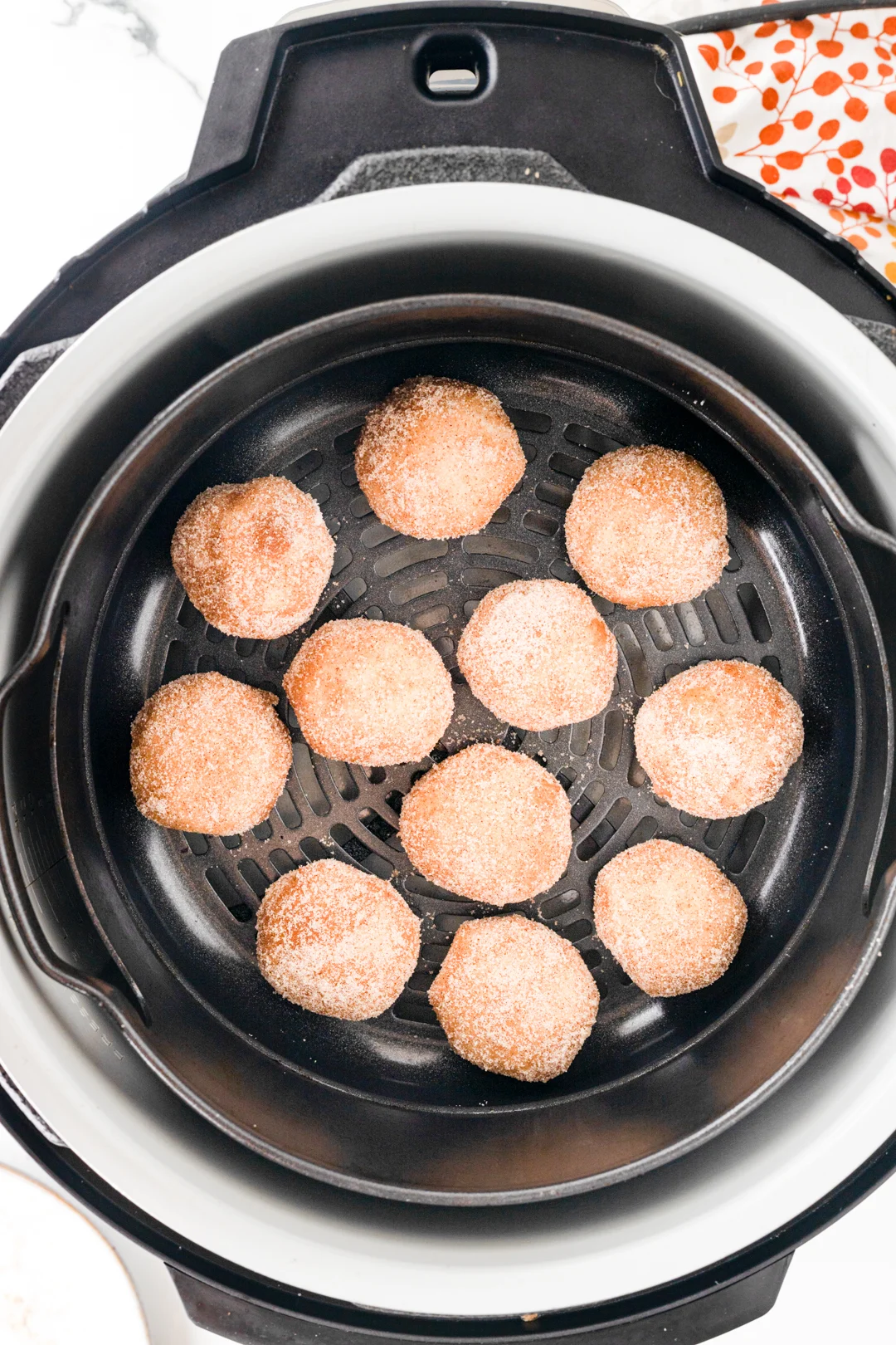 donut holes placed into air fryer before cooking