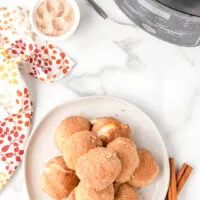pumpkin spice donut balls stacked on a plate