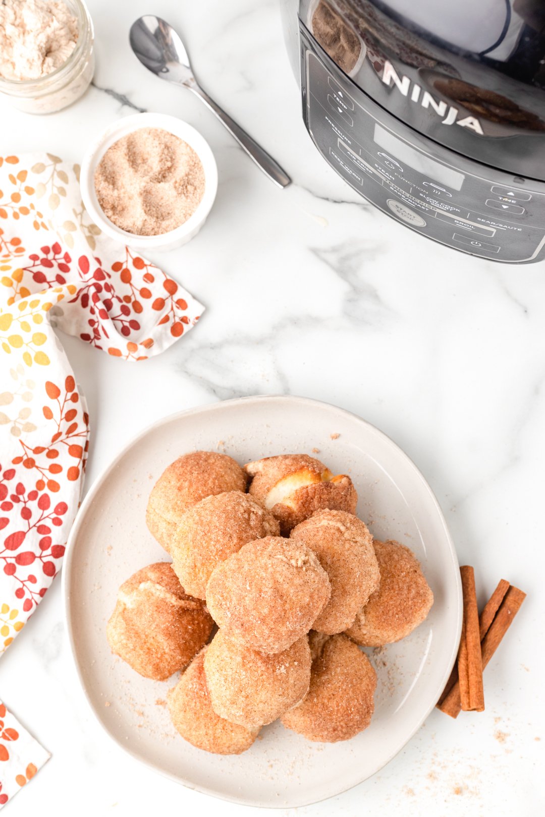 pumpkin spice donut balls stacked on a plate