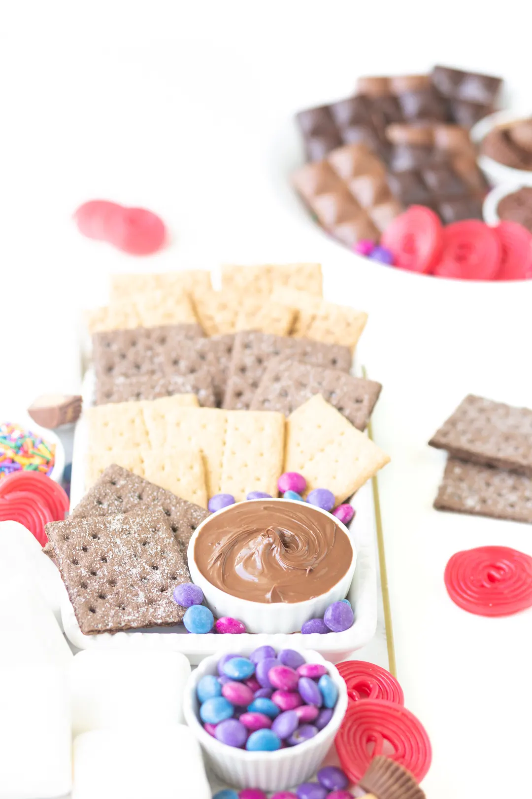 s'mores dessert platter filled with three varieties of graham crackers, candies, chocolates and marshmallows