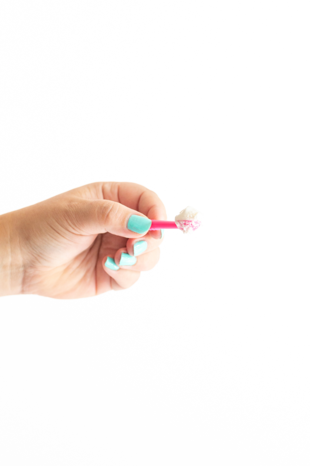 tiny pink ice cream scoop with tiny scoop of vanilla ice cream on top