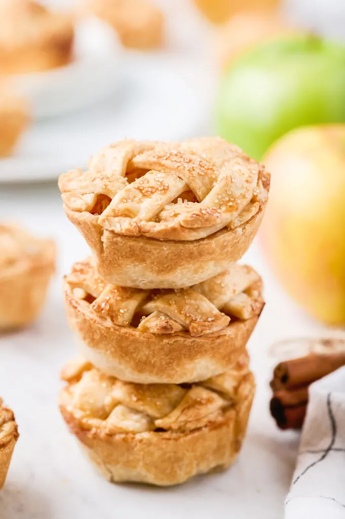muffin tin apple pies stacked on top of each other