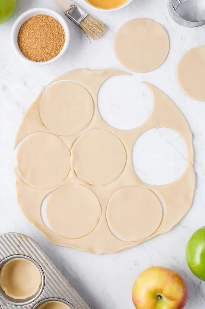 cutting circles out of dough for mini pies