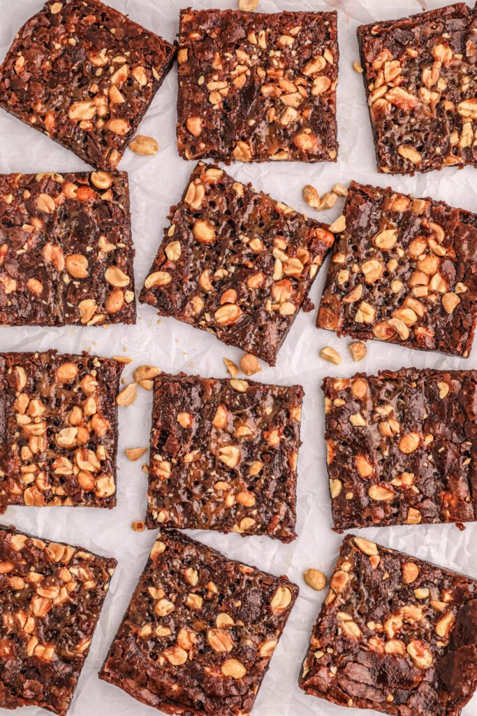 chewy style brownies prepared, cut and spread out on wax paper.