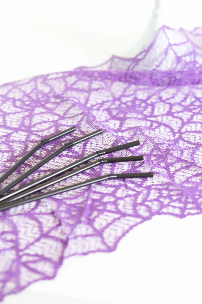 black straws to be used to insert into a chocolate cake spider