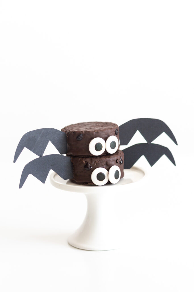 two bat snack cakes stacked on top of each other made out of ding dongs