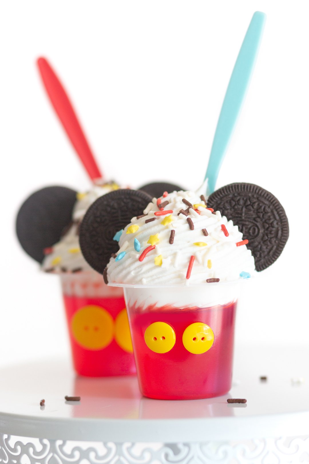 mickey mouse desserts for a part. Gelatin cups topped with whipped cream, sprinkles and OREO cookie ears.