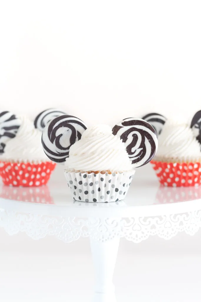 mickey mouse themed cupcakes served on a cake stand
