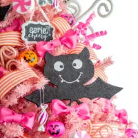 pink halloween tree with cute bats, mini jackolantern buckets as ornaments, fluffy pink bows and coral striped ribbon