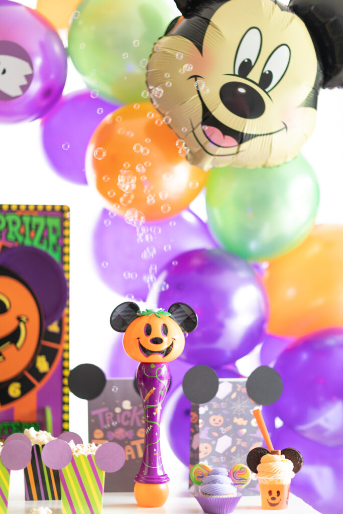 mickey balloons in background, disney parks bubble machine with mickey pumpkin on it up front