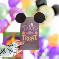 mickey mouse halloween treat bag being held by sally from nightmare before christmas