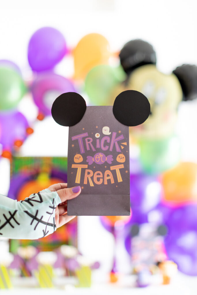 mickey mouse halloween treat bag being held by sally from nightmare before christmas