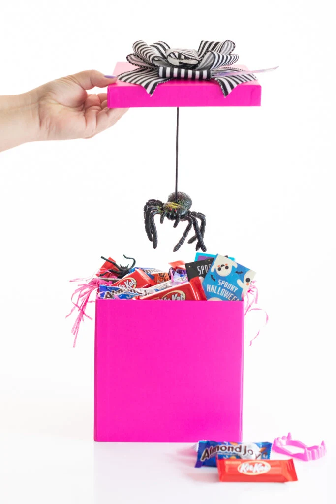 surprise spider on a string revealed when you take the top off of the halloween gift boxes filled with hershey treats