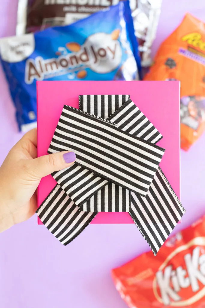 making a diy bow with wired ribbon and a glue gun.