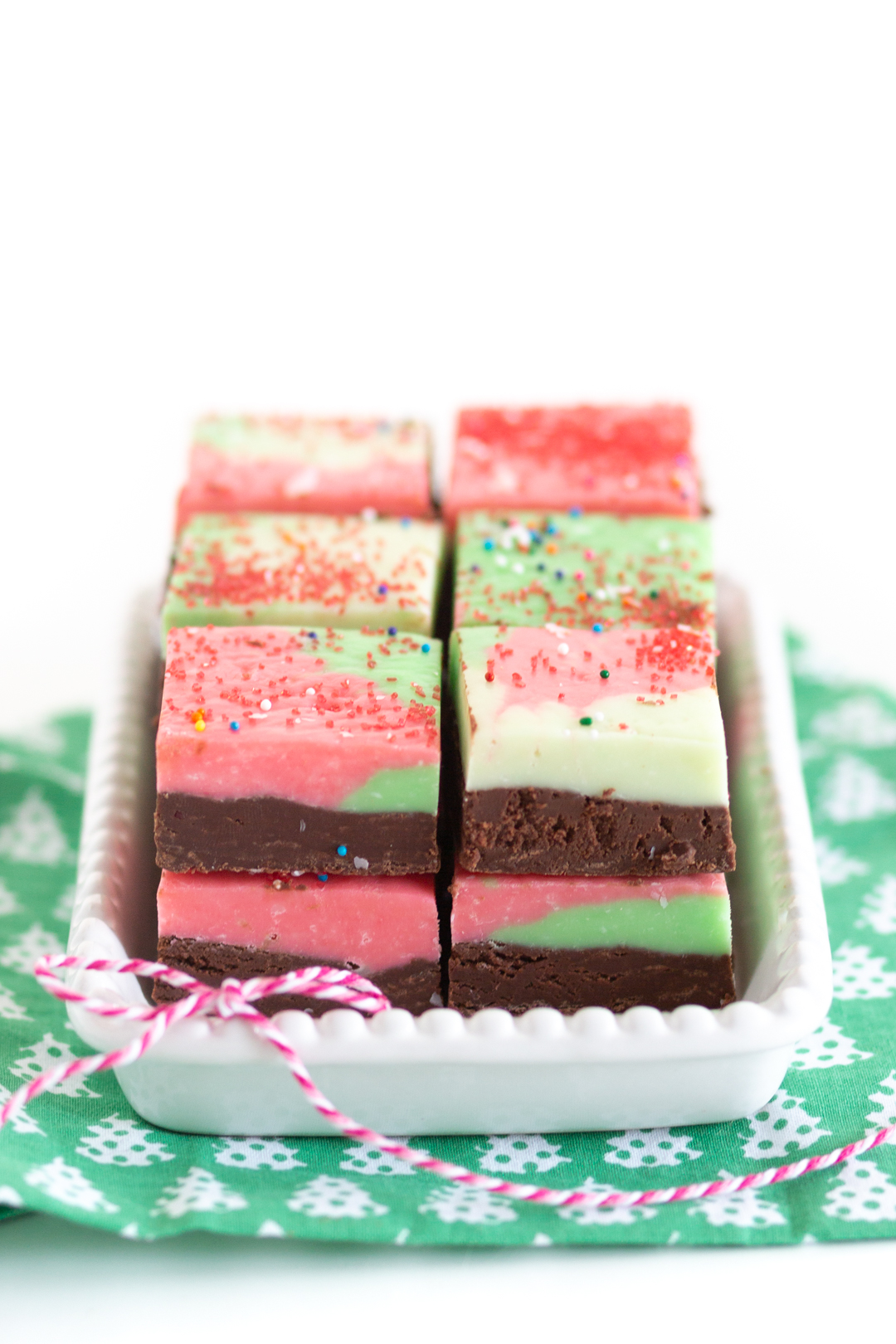 straight on view of christmas themed fudge on a small serving platter