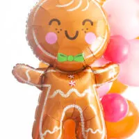 extra large gingerbread man foil balloon with cute smiley face and pink circles for cheeks