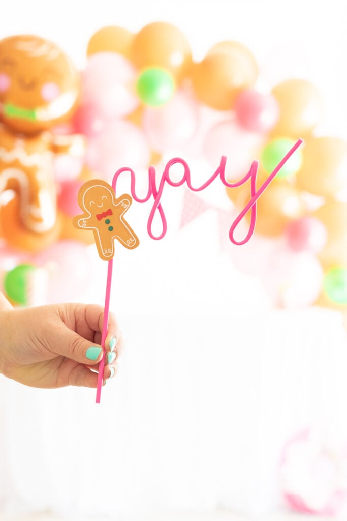 pink gingerbread man themed straw that says "yay"