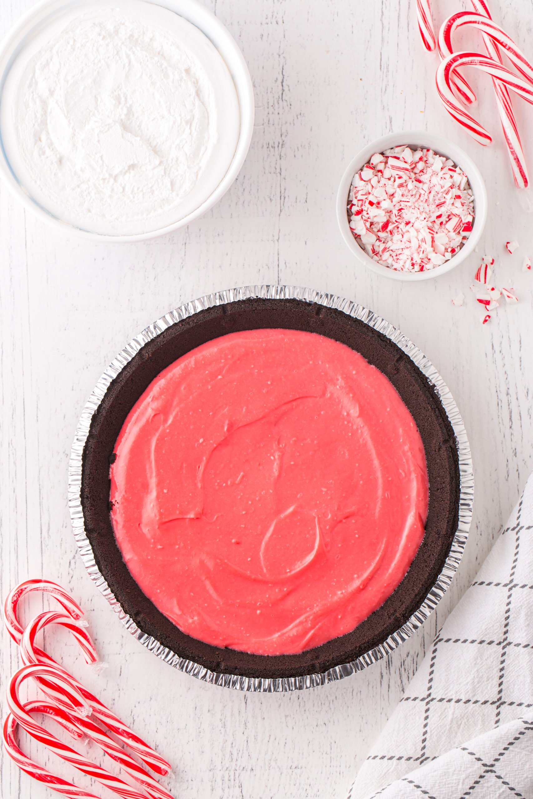 red layer of peppermint layered pie poured inside a store-bought oreo pie