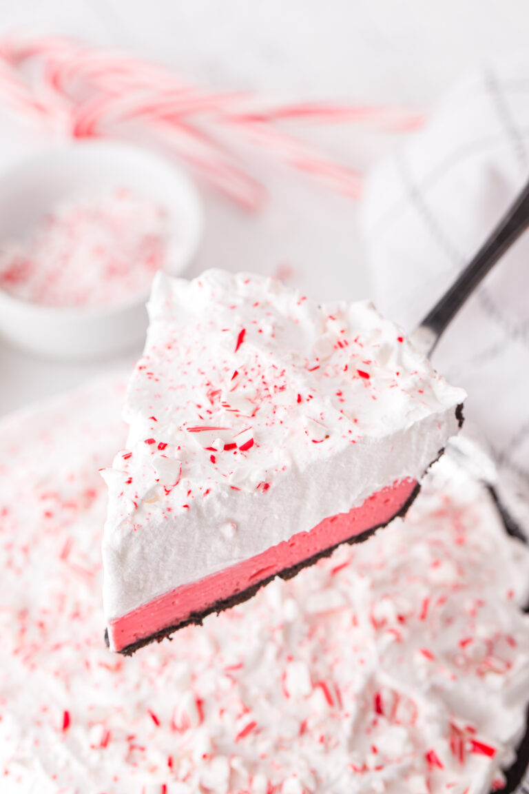 layered peppermint pie cut from the whole pie and being served on a pie spatula