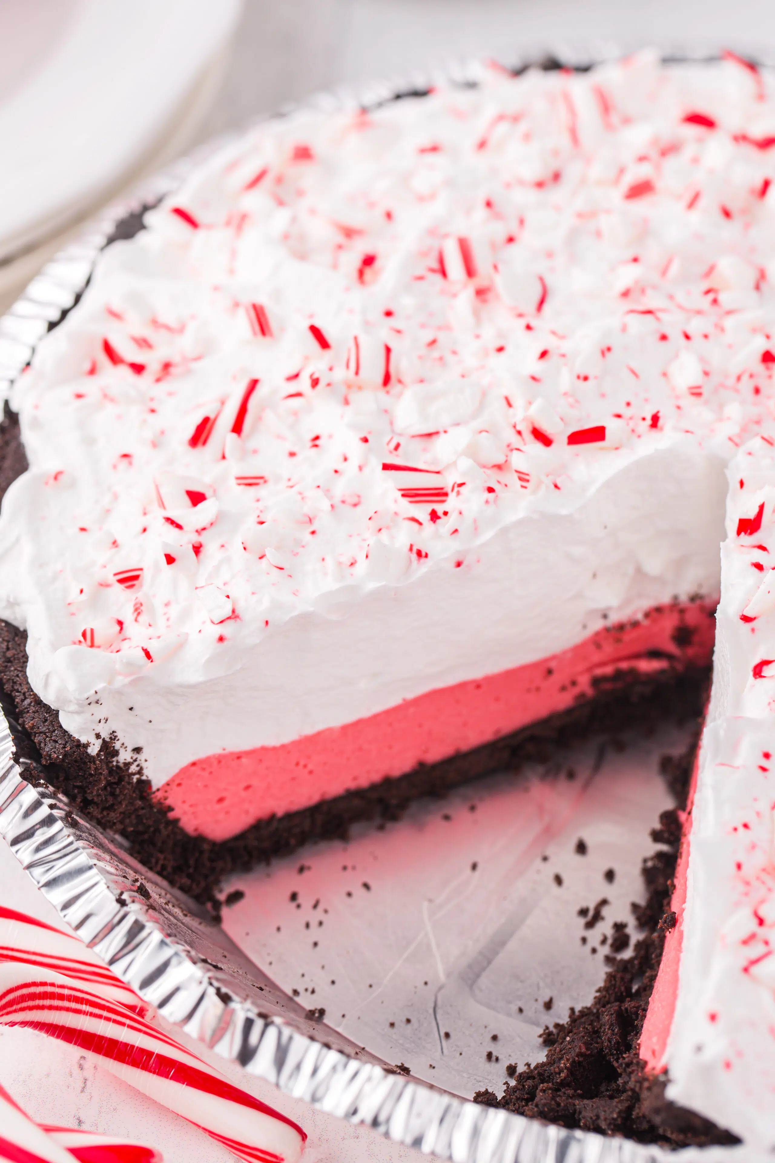 look into layered peppermint pie from a side angle. See the oreo crust layer, peppermint marshmallow layer and whipped topping layer.
