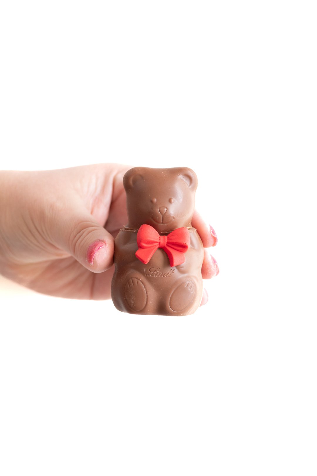 teddy bear hot cocoa melt with a red icing bow attached