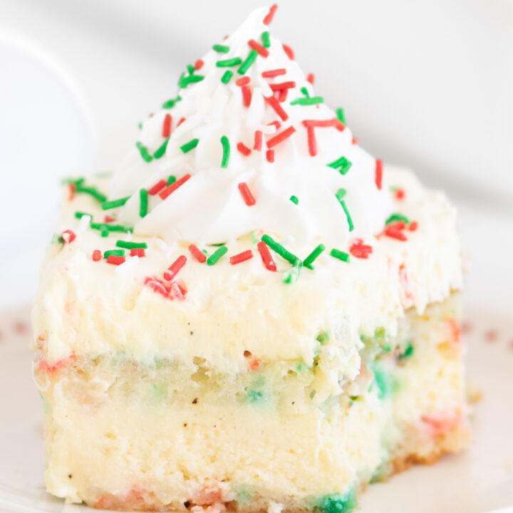 pretty holiday cake with a bite taken out of it with a fork