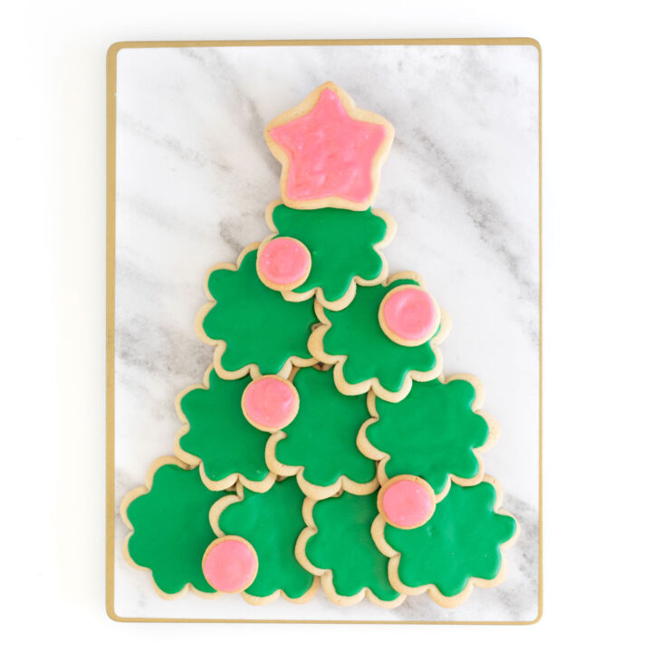christmas tree made out of sugar cookies using a flower cookie cutter and a star cookie cutter for the tree topper.