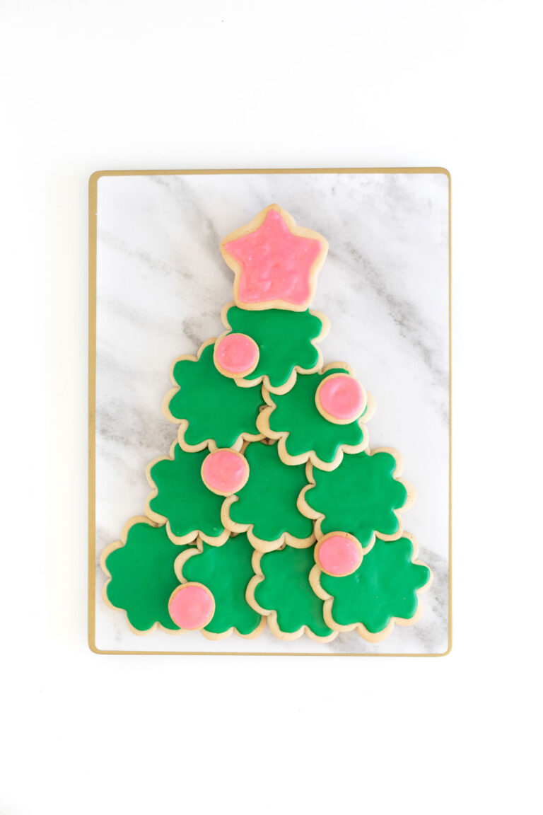 christmas tree made out of sugar cookies using a flower cookie cutter and a star cookie cutter for the tree topper.