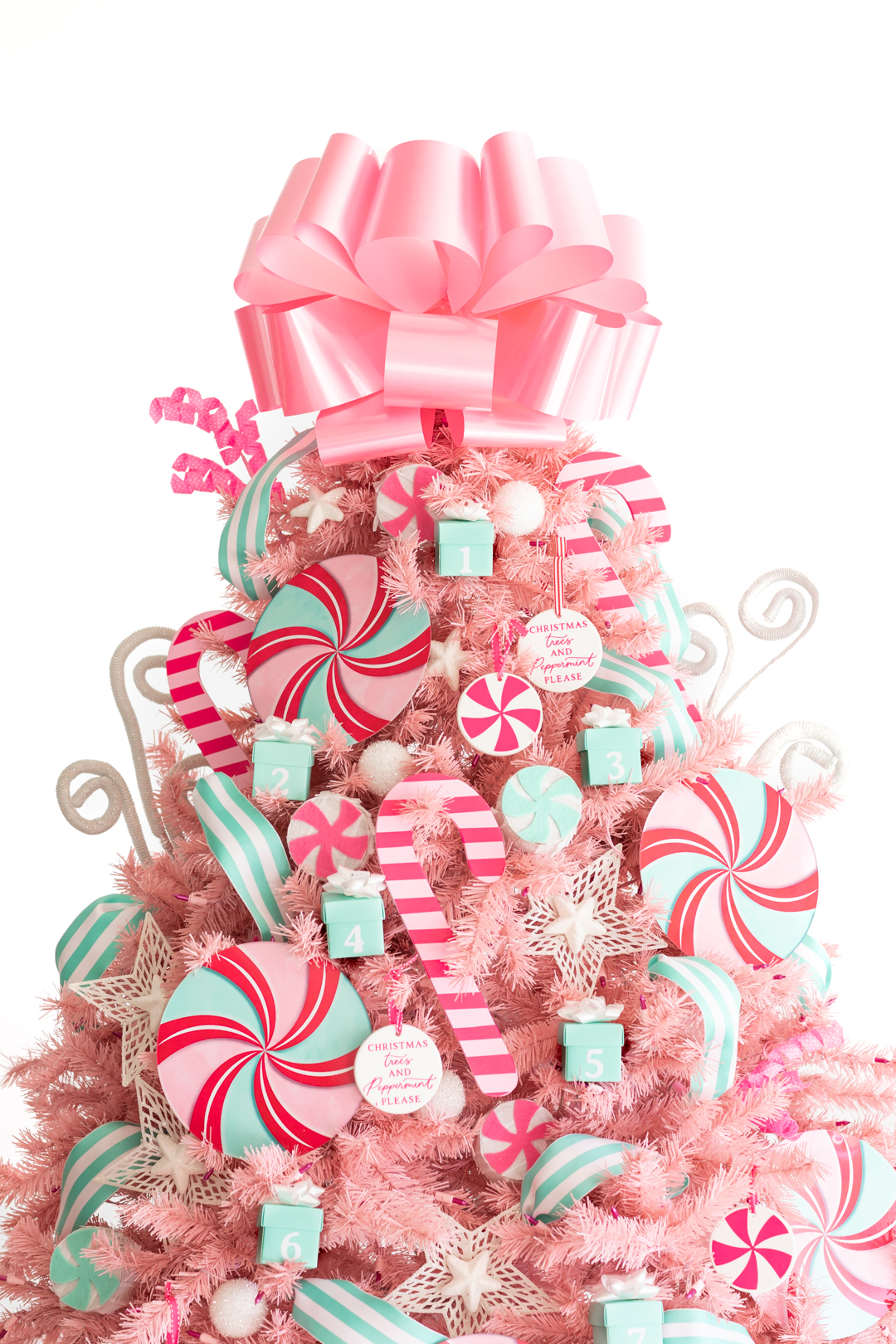 pretty pink christmas tree decorated with pink pepermint themed ornaments