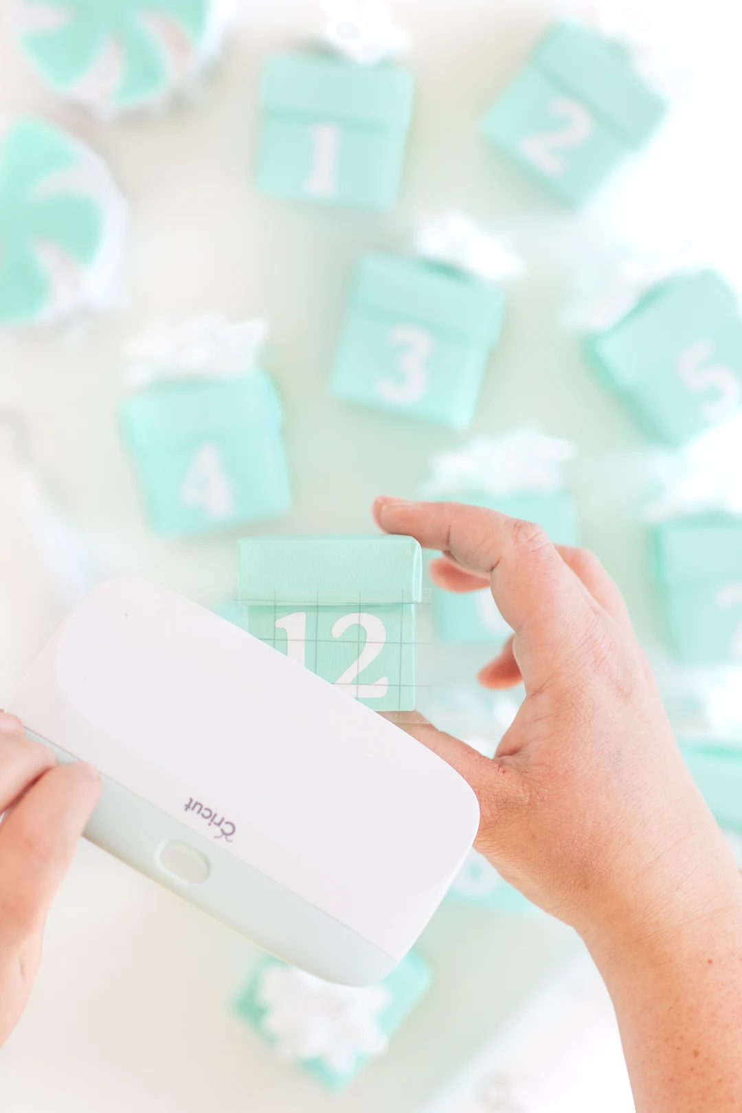 Adding cricut numbers to mini teal gift boxes for an advent countdown